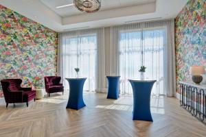 a room with floral wallpaper and blue tables at Hampton Inn & Suites Nashville Downtown Capitol View, Tn in Nashville +47 photos
