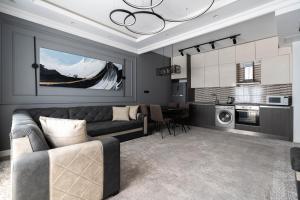 a living room with a couch and a kitchen at Istanbul Apartment 01 in Tashkent