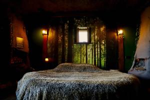 a bedroom with a bed with a window and lights at City Hotel Restaurant Stadskanaal in Stadskanaal +16 photos