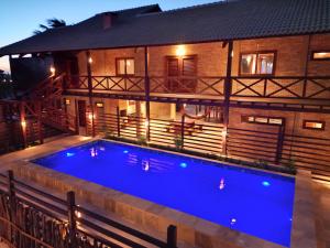 a swimming pool in front of a house at night at BEACH HOUSE - Loggia Suite 4 - com cozinha - na praia -BEACHFRONT in Barra Grande