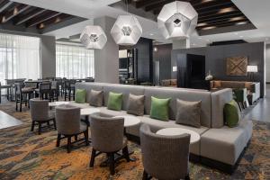 a lobby with a couch and tables and chairs at Homewood Suites Springfield in Springfield