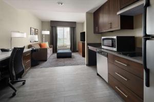 a kitchen with a desk and a living room at Homewood Suites Springfield in Springfield