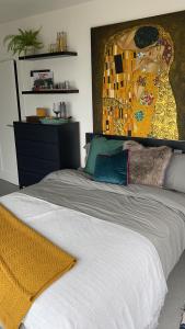 a bedroom with a bed with a yellow blanket on it at Newpark in Cobh
