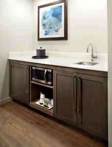 a kitchen with a sink and a counter at Hampton Inn & Suites Pittsburgh Airport South/Settlers Ridge in Robinson Township