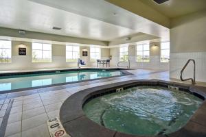 a large indoor pool in a building with a swimming pool at Homewood Suites By Hilton Salt Lake City Airport in Salt Lake City