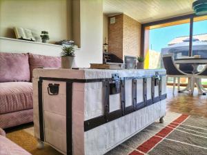 a living room with a wooden chest in front of a couch at La Mirada de Amelia in Tabera de Abajo