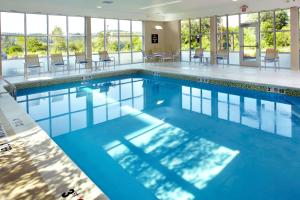 a large swimming pool with blue water in a building at Homewood Suites by Hilton Pittsburgh Airport/Robinson Mall Area in Moon Township