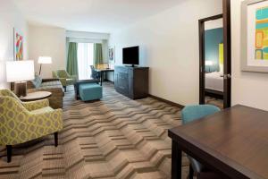 a living room with a room with a bed and a table at Homewood Suites By Hilton Edina Minneapolis in Edina