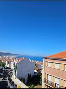 a view of a city with the ocean in the background at Apartamento MARQUES in Nazaré