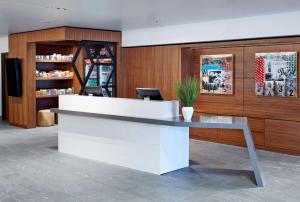 a lobby with a white counter with a potted plant at Doubletree By Hilton Atlanta Perimeter Dunwoody in Atlanta