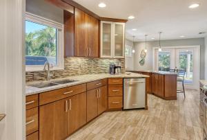 a large kitchen with wooden cabinets and a sink at Mermaids Oasis - 315 in Bailey Hall