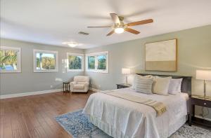 a bedroom with a bed and a ceiling fan at Mermaids Oasis - 315 in Bailey Hall