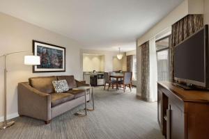 a living room with a couch and a flat screen tv at Hampton Inn & Suites Nashville-Downtown in Nashville