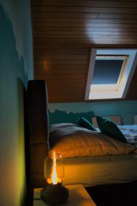 1 dormitorio con 1 cama y 1 vela sobre una mesa en KomfortZuhause in Wermelskirchen, en Wermelskirchen