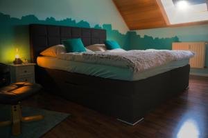 a bedroom with a large bed with green walls at KomfortZuhause in Wermelskirchen in Wermelskirchen