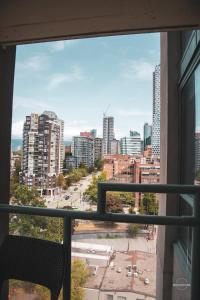 a view of a city skyline from a window at Stunning ocean (sound of waves) in Vancouver