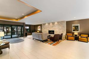 a living room with furniture and a fireplace at Embassy Suites by Hilton Chicago North Shore Deerfield in Deerfield