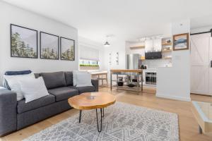 a living room with a gray couch and a table at Powderview 12 by Whistler Premier in Whistler