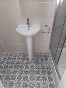 a bathroom with a sink and a shower at Dodi Aparts London, near Stratford close to tube station in London