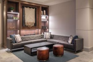 a living room with a couch and a table at Hilton Columbus/Polaris in Columbus