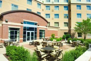 a patio with tables and chairs in front of a building at Homewood Suites by Hilton Pittsburgh-Southpointe in Canonsburg