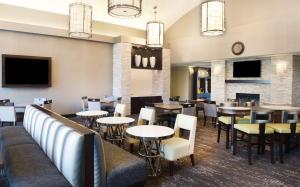 a dining room with tables and chairs and a fireplace at Homewood Suites by Hilton Pittsburgh-Southpointe in Canonsburg