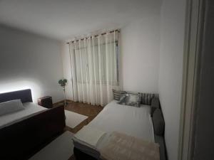a small room with a bed and a couch at Plaža Stari Grad Budva pjena od mora Beach Apartman in Budva