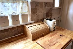 a kitchen with a counter with a toaster and a window at Quirky City-Centre Cottage in Exeter