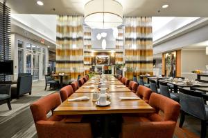 a large dining room with a long table and chairs at Hilton Garden Inn Austin Round Rock in Round Rock