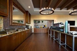 a large kitchen with wooden cabinets and a counter at Homewood Suites by Hilton Baltimore in Baltimore