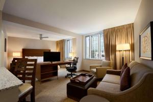 a hotel room with a bed and a desk at Homewood Suites by Hilton Baltimore in Baltimore