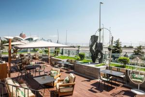 a rooftop patio with tables and chairs and a fountain at Sheraton Baku Intourist in Baku