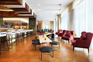 a lobby with chairs and tables and a bar at Sheraton Baku Intourist in Baku