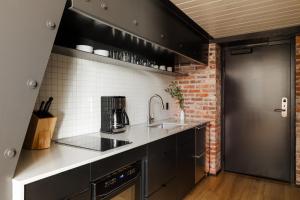 a kitchen with a sink and a brick wall at Sonder RailSpur in Seattle
