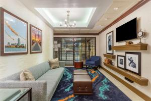 a living room with a couch and a tv at Hampton Inn Boston/Peabody in Peabody