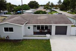 a white house with a garage and a driveway at Stadium Sunflower Miramar home, 3 bd, 2 ba in Miramar