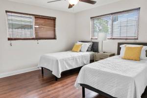 a bedroom with two beds and a ceiling fan at Stadium Sunflower Miramar home, 3 bd, 2 ba in Miramar
