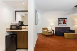 a living room with a couch and a chair at Hampton Inn Champaign/Urbana in Urbana