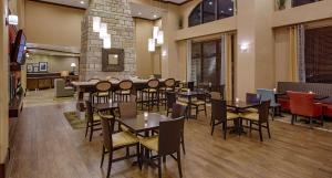a restaurant with tables and chairs in a room at Hampton Inn & Suites Legacy Park-Frisco in Frisco