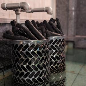 a metal bucket full of cigars sitting next to a sink at The Bed and Spa - Vacation STAY 15981v in Tokorozawa