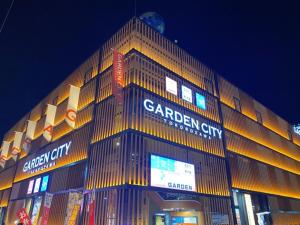 a large building with lights on it at night at The Bed and Spa - Vacation STAY 15981v in Tokorozawa