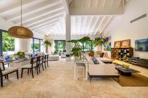 a living room with a table and a dining room at Sunny Vacation Villa No 77 in San Rafael del Yuma