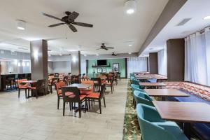 - un restaurant avec des tables et des chaises et un ventilateur de plafond dans l'établissement Hampton Inn Orlando-Convention Center International Drive Area, à Orlando