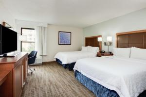 a hotel room with two beds and a flat screen tv at Hampton Inn Orlando-Convention Center International Drive Area in Orlando