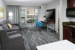 a living room with a couch and a desk in a hotel room at Hampton Inn & Suites Memphis-Beale Street in Memphis