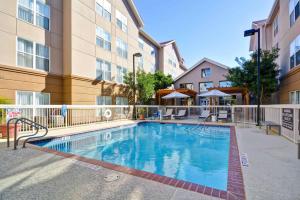 a swimming pool in the courtyard of a apartment building at Homewood Suites by Hilton San Antonio Northwest in San Antonio