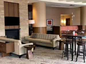 a lobby with a couch and tables and a fireplace at Hilton Garden Inn Baltimore Inner Harbor in Baltimore