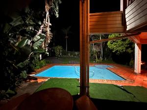 a swimming pool in a yard at night at The Wood House in Empangeni