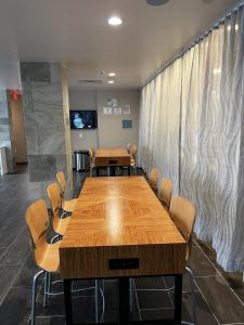 a conference room with a wooden table and chairs at Home2 Suites By Hilton Hinesville in Hinesville