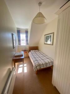 a bedroom with a bed and a table in it at Faithlegg Estate, Mews Holiday Home, Waterford in Waterford